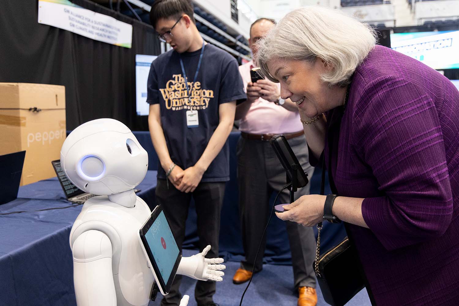 GW President Ellen Granberg interacting with an AI robot demonstration